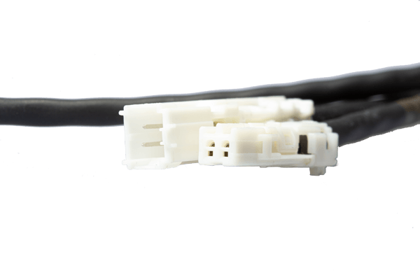Close-up of a white AMEC automotive connector with dual black cables, highlighting MD ELEKTRONIK's focus on reliable electrical connections for vehicle systems.