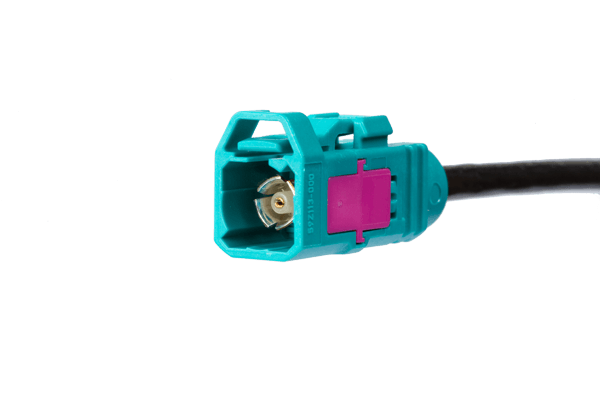 Close-up of a turquoise and magenta FAKRA automotive connector, highlighting MD ELEKTRONIK's precision in vehicle cable assembly.