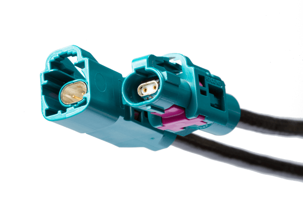 Turquoise and magenta H-MTD automotive connectors with dual ports for enhanced connectivity in vehicle data systems.